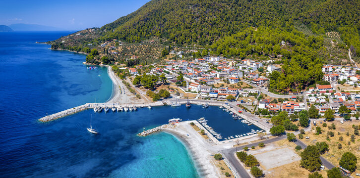 Aerial summer day view of the idyllic village, marina and beaches at Neo Klima, Skopelos island, Sporades, Greece<