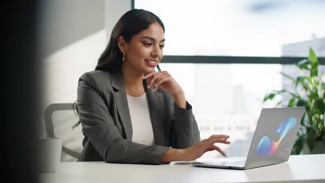 A diverse professional in business-casual attire concentrates at a minimalist desk with a laptop displaying data, their expression shifting to a knowing smile and nod, symbolizing an 'aha!' moment of