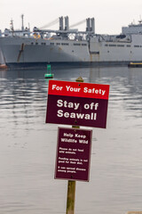 Fototapeta premium Baltimore, Maryland USA A sign in the Fort McHenry National Monument Park says Stay off Seawall.