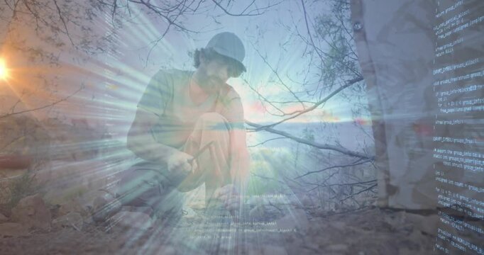 man kneeling using rock hammer and chisel on rocky ground, with animated light rays for education