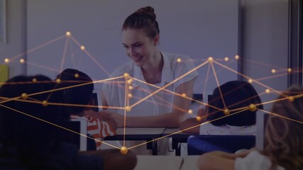 Educator in classroom gesturing toward student guiding to worksheet while digital overlay pulsating - Powered by Adobe