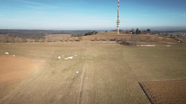 Captivating drone forward flight over golden fields, hills, and TV tower under blue skies. 4K UHD 25fps smooth tracking evokes peace. Ideal for travel promos, nature docs, corporate BGs.