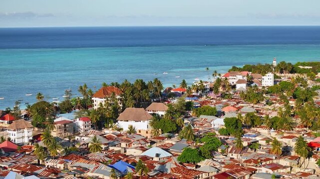 Cinematic drone 3x zoom shot flying over Nungwi in Zanzibar. Detailed aerial view of tropical coastline, white sand, and island life creates a stunning and immersive travel scene for tourism projects.