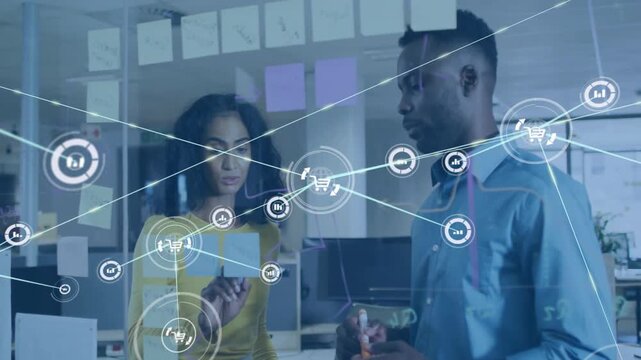 Woman writing on glass and man gesturing initiating data network visualizing business metrics