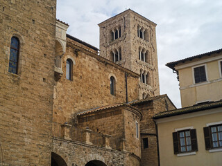 Fototapeta premium Medieval Italian street perspective showcasing the historic Anagni Cathedral apses and stone buildings under a cloudy sky in Lazio, Italy