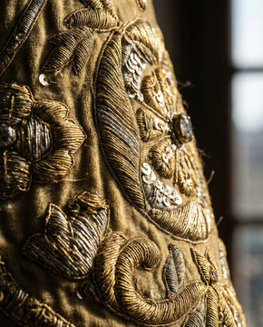 Detalle macro de bordado dorado en manto procesional