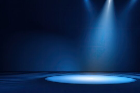 A dark blue backdrop is highlighted with three stage spotlights on a circular stage floor
