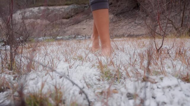 Woman walks barefoot in the snow for hardening