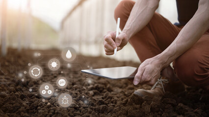 Farmer checks soil quality by hand using digital data icons to analyze nutrients pH moisture with...