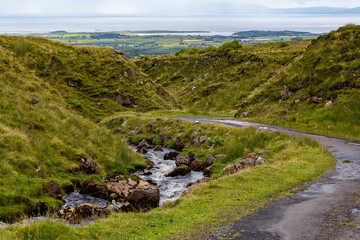 a small natural mountain river along the hiking path at the bottom of ben bulben mountain in sligo, ireland