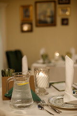 Woman in Red Dress Setting Festive Christmas Dinner Table with Garland
