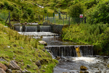 a small natural mountain river along the hiking path at the bottom of ben bulben mountain in sligo, ireland