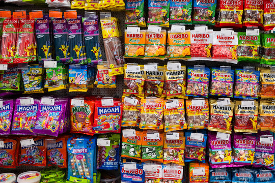LUBIN, POLAND - JANUARY 15, 2026: Shelves in a supermarket filled with various colorful Haribo and Maoam gummy candies and sweets in plastic packaging.