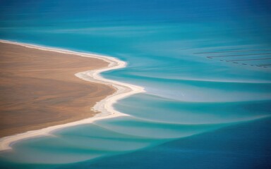 A striking contrast of colors at the meeting point of desert land and turquoise sea