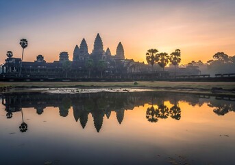 Fototapeta premium Sunrise at Angkor Wat — Temple Reflection in Lotus Pond at Dawn