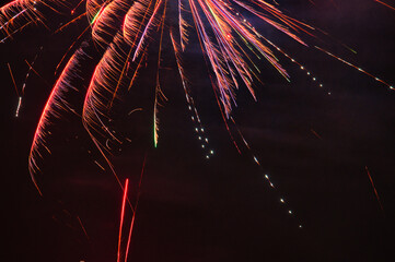 Spektakularny nocny pokaz fajerwerków na ciemnym niebie z wielobarwnymi smugami. © Pol Badger