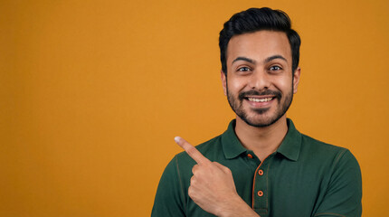 Happy Indian Man Pointing Sideways on Orange Background