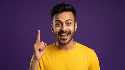 Happy Young Indian Man Pointing Up with Great Idea