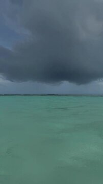 Rain in the Indian Ocean, clear turquoise water, human hand underwater. Ukulhas, Maldives
