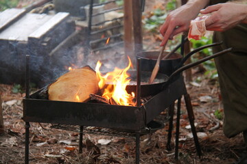 Cooking Bacon in a Frying Pan on an Outdoor Wood Fire.