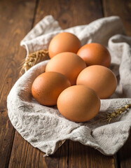 farm fresh eggs on linen towel with wooden background