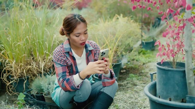 Young Woman Using Smart phone in Garden
