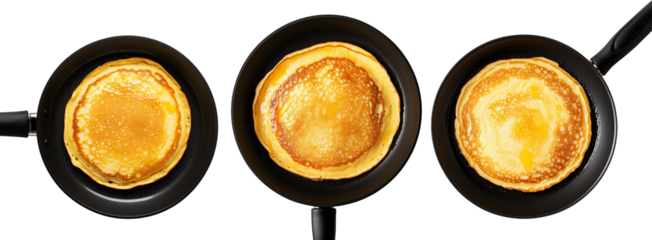 Golden Old-Fashioned Pancakes in a black non-stick frying pan, isolated from above on a white transparent background.