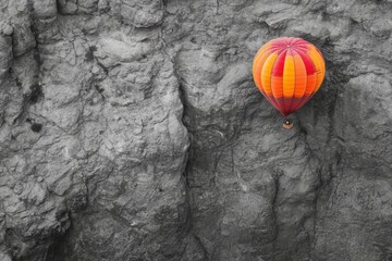 Vibrant hot air balloon against rocky cliff backdrop