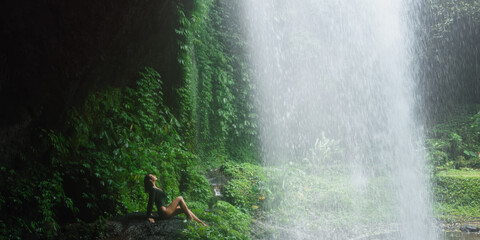 Tranquil Moment Under Jungle Waterfall at Banyu Wana Amertha, Bali