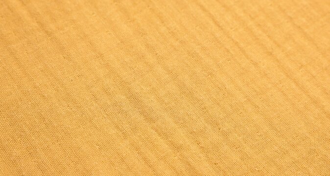 Texture of bright orange fabric as background, closeup