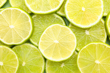 Fototapeta premium Fresh lime slices as background, top view