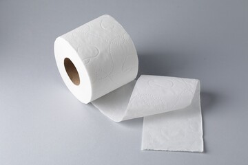Toilet paper roll on light grey background, closeup