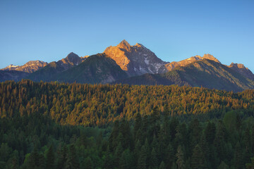 Nature landscape of sunlight mountain peak panorama and forest valley.