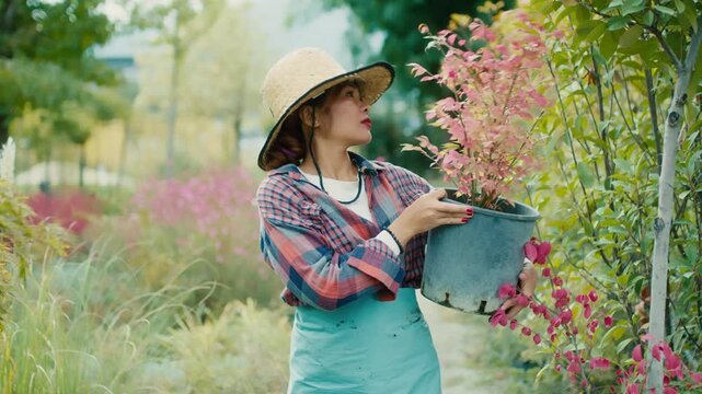 Woman with potted plant in a vibrant garden