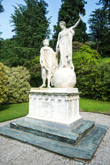 Obraz premium statue of the king and queen in the garden. Marble Statue of Allegorical Figures in a Lush Green Garden