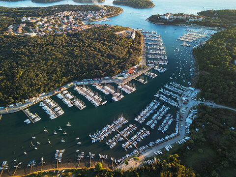Pula Croatia aerial drone view of island coastline Adriatic sea bay and moored boats.
