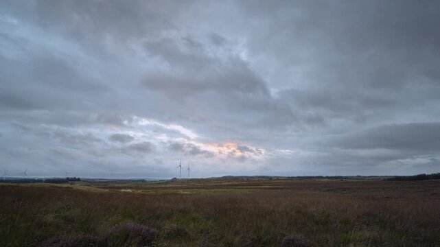 Aerial: A drone footage of a countryside and wind power turbines. West Lothian, Scotland