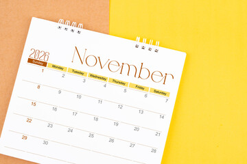 November 2026 desk calendar on brown and yellow, Planning for business.