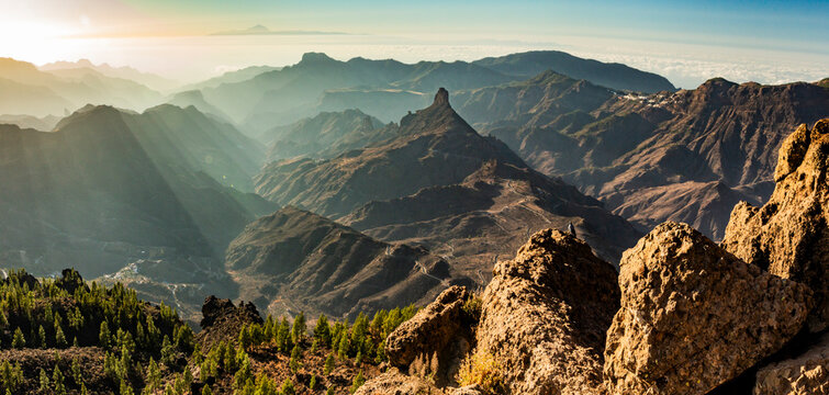 Roque Bentayga, mountains and valleys from Roque Nublo, Gran Canaria. Sunset, Tenerife in background