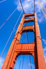 Obraz premium Golden Gate Bridge pedestrian walkway with red cables and blue sky
