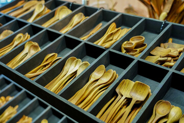 Stack of wooden turner,&nbsp;ladle and spoons trays in traditional souvenirs shop for sale.