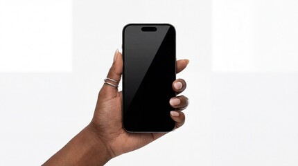 A hand holding a black smartphone with a blank screen isolated on white background