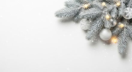 Christmas tree branches with silver ornaments and lights on a white background.