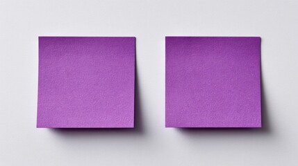 Two purple sticky notes on a textured white surface, showcasing their vibrant color and simple design.