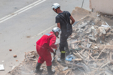 Rescue workers clearing debris at collapsed building site