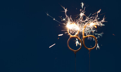 86 years anniversary celebration festive background made with Bengal fires in the form of number Eighty six.