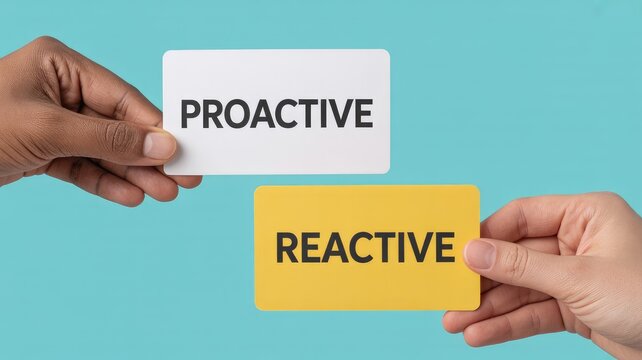 Hands holding proactive and reactive cards for business strategy