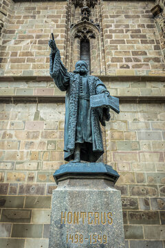 Statue of Johannes Honterus in front of Biserica Neagra - Black Church, main landmark of Old Town of Brasov, Romania