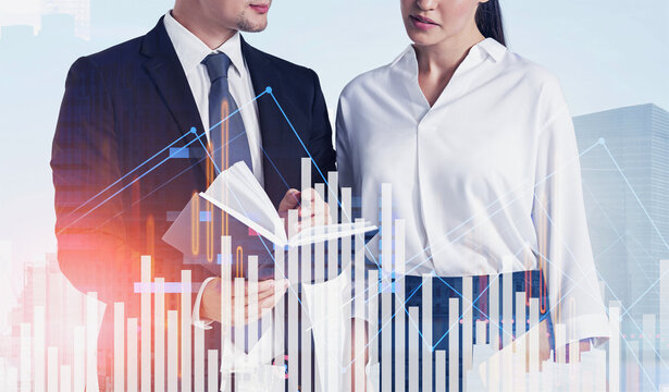 Two business people reviewing notes with abstract bar and line charts overlay, modern corporate concept on city background illustrating financial strategy - Powered by Adobe