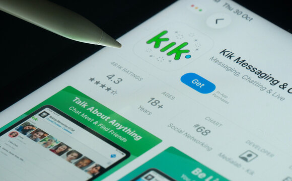 Dhaka, Bangladesh- 30 Oct 2025: Kik app on a iPad screen with a pen pointing at the install option.